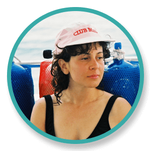 a woman wearing a pink hat with the word club on it